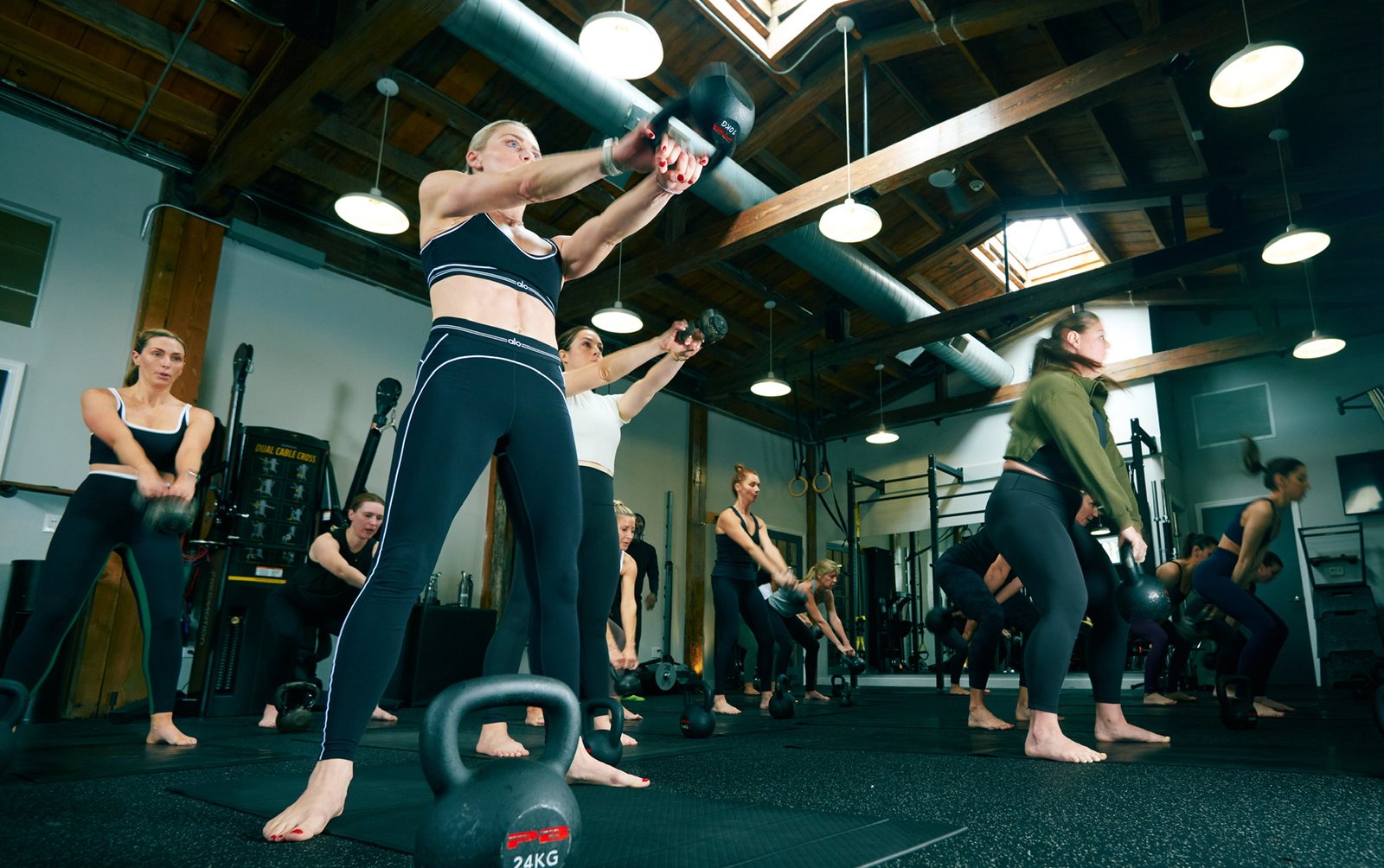 A kettlebell class mid-swing on the training floor
