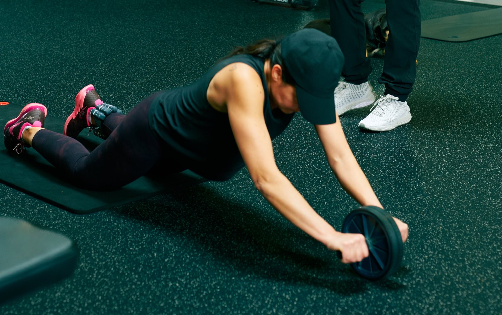 An ab-wheel rollout coached on the personal training floor